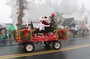 Santa and Mrs. Clause ride in the Rotary Flyer.